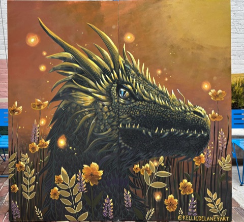 A black dragon surrounded by golden flowers and glowing lights